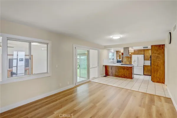 a large space with a large window and wooden floor