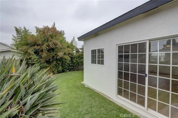 a house that has a palm tree in front of it