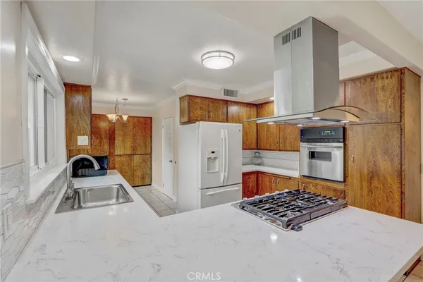 a kitchen with a refrigerator a sink and a stove