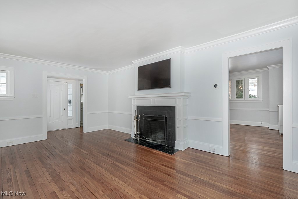 2596 Ashton Road Cleveland, OH 44118 - Photo 12 of 43 Unfurnished living room featuring dark hardwood / wood-style flooring and ornamental molding