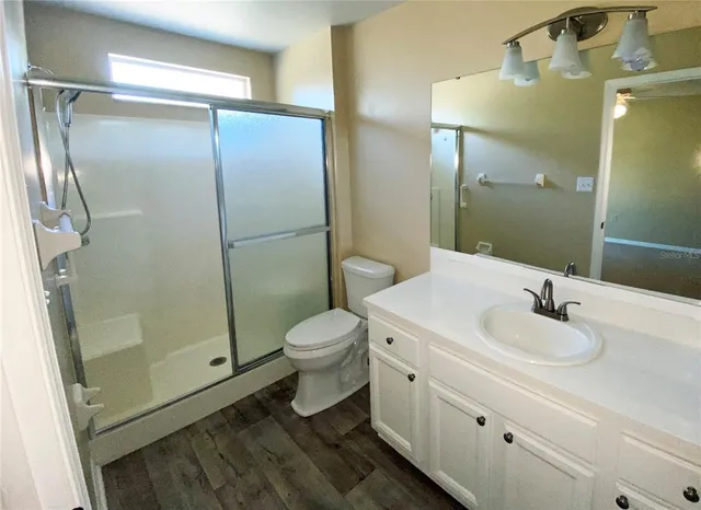 a bathroom with a sink toilet and shower
