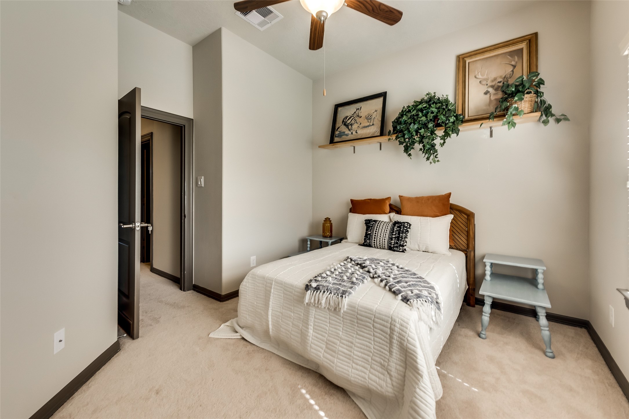 86 Aventura Place Spring, TX 77389 - Photo 14 of 23 a bedroom with a bed and a chandelier