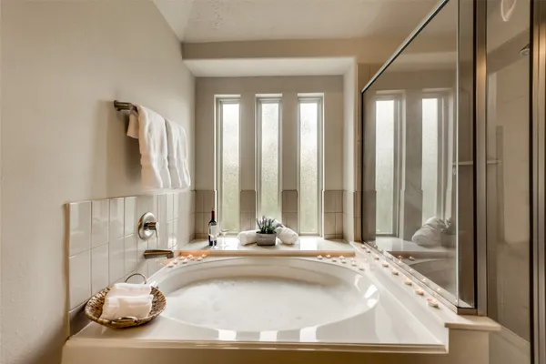 a view of a bathroom with tub and window