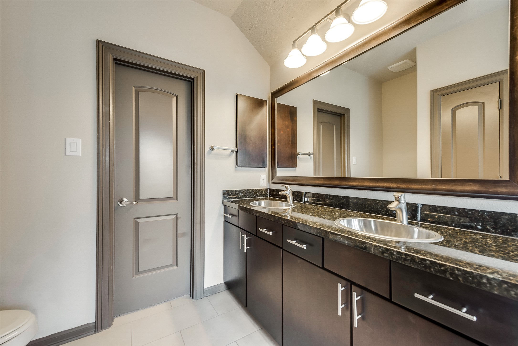 86 Aventura Place Spring, TX 77389 - Photo 20 of 23 a bathroom with a granite countertop sink and a mirror