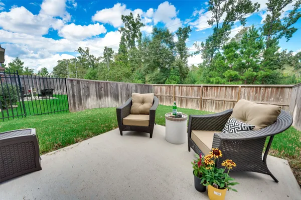 a view of a patio with couches chairs and a yard