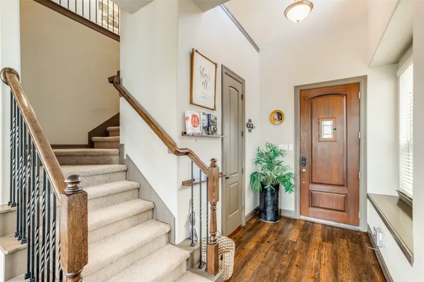 a view of entryway with wooden floor and stairs
