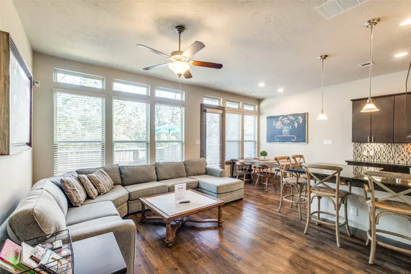 a living room with furniture and wooden floor