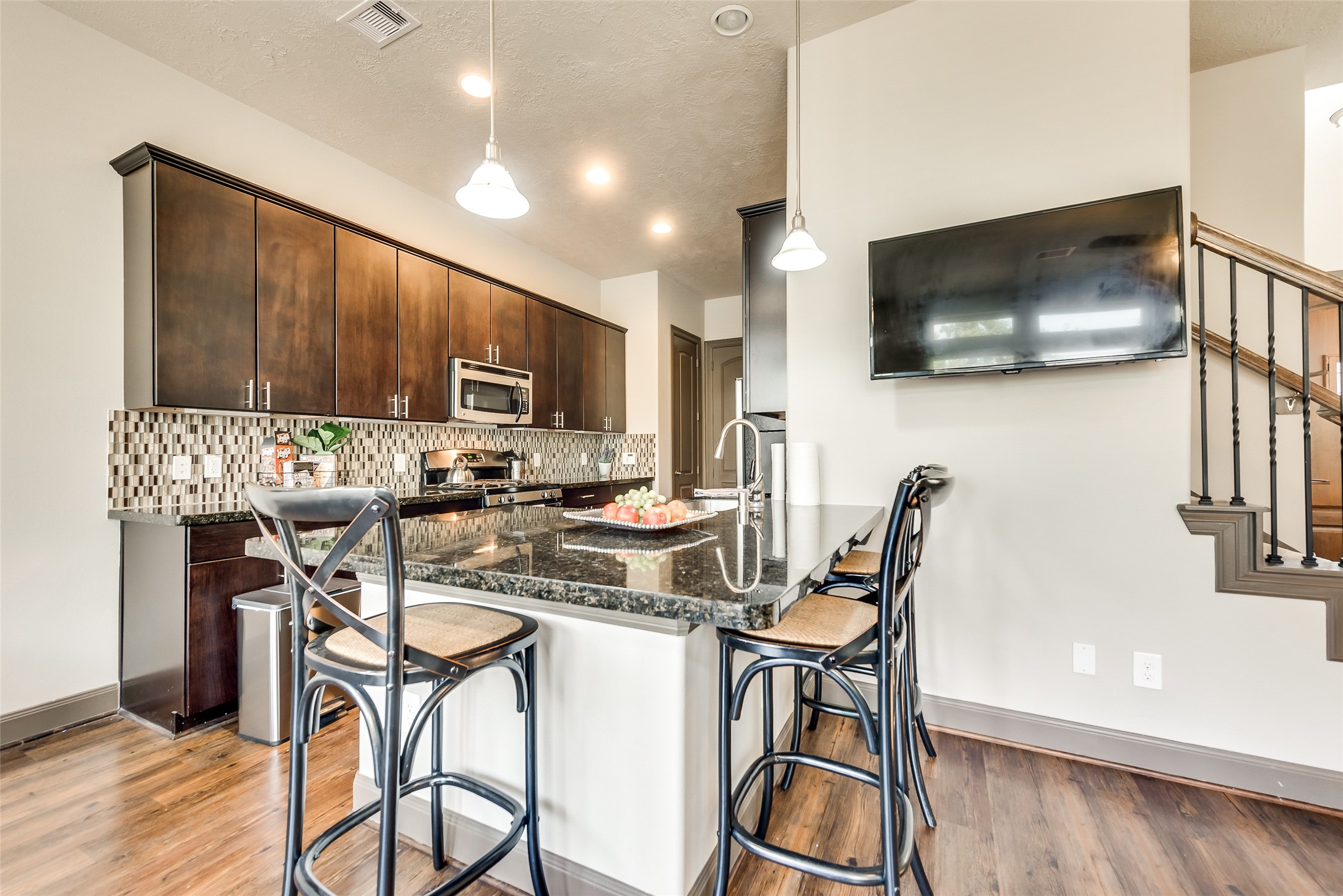 86 Aventura Place Spring, TX 77389 - Photo 7 of 23 a kitchen with a table chairs refrigerator and microwave