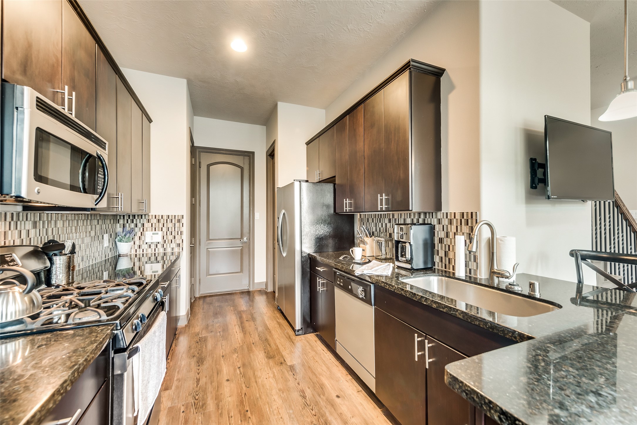 86 Aventura Place Spring, TX 77389 - Photo 8 of 23 a kitchen with stainless steel appliances granite countertop a sink stove and refrigerator