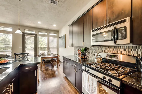 a kitchen with stainless steel appliances a stove sink and cabinets