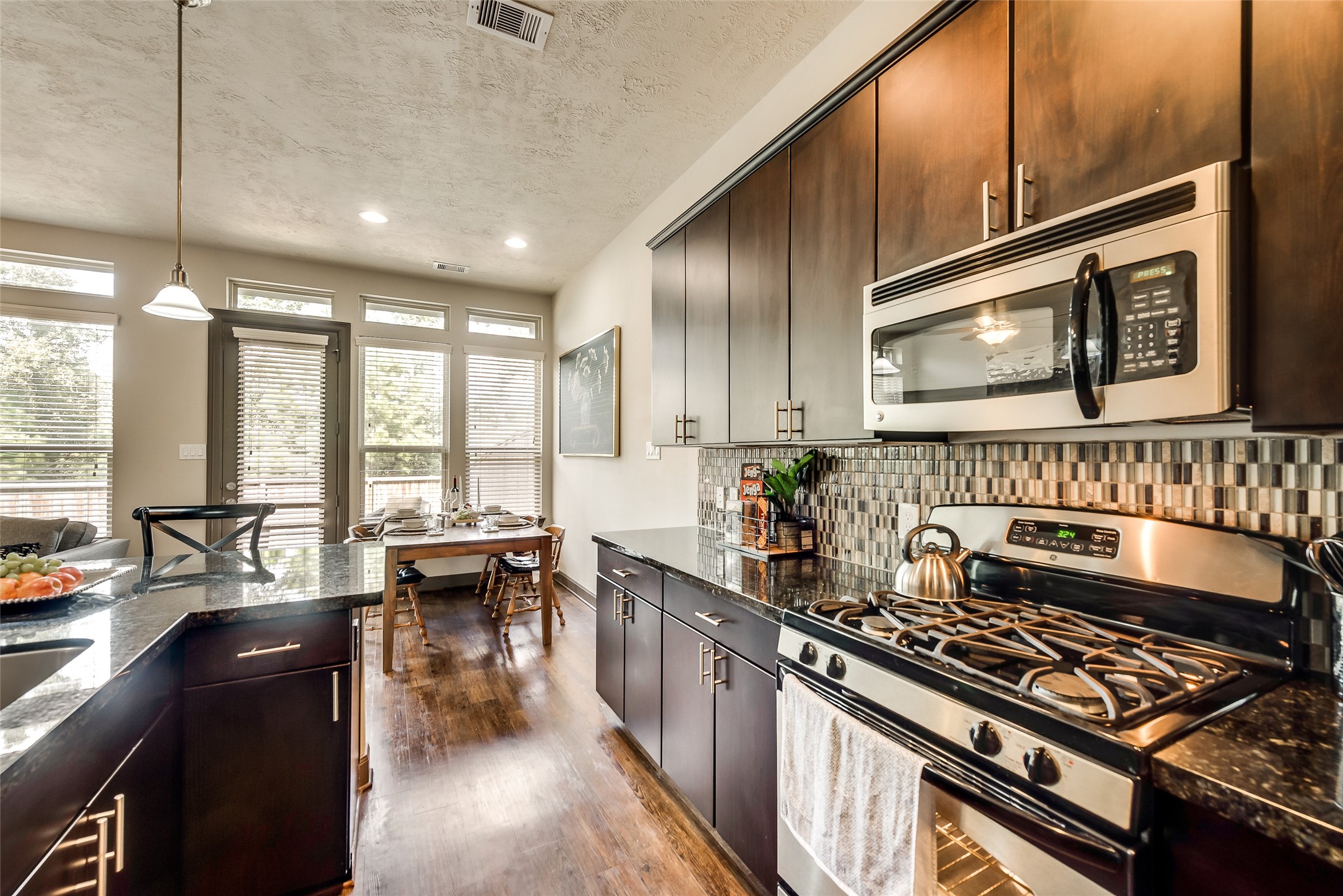 86 Aventura Place Spring, TX 77389 - Photo 9 of 23 a kitchen with stainless steel appliances a stove sink and cabinets