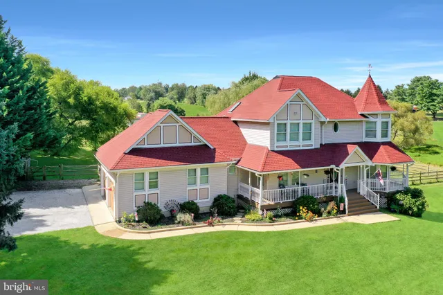 a front view of a house with yard and green space