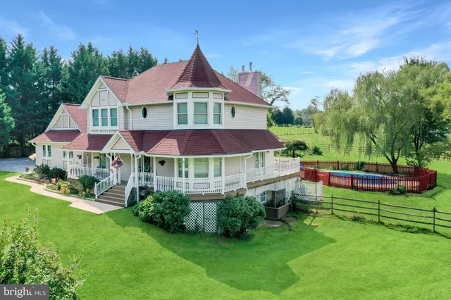 a view of a house with backyard porch and sitting area