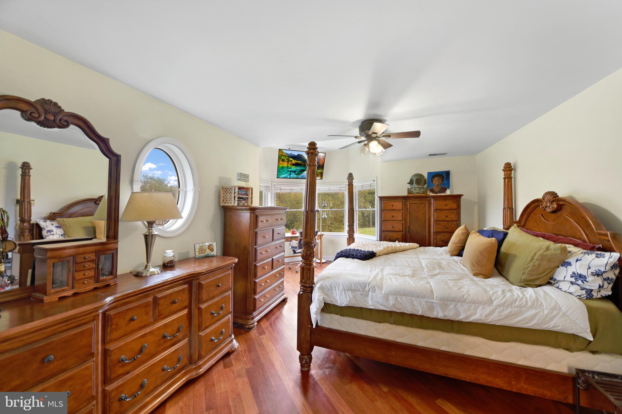 760 Gilbert Road Aberdeen, MD 21001 - Photo 28 of 50 a bedroom with a bed a mirror on dresser and a large mirror next to a window