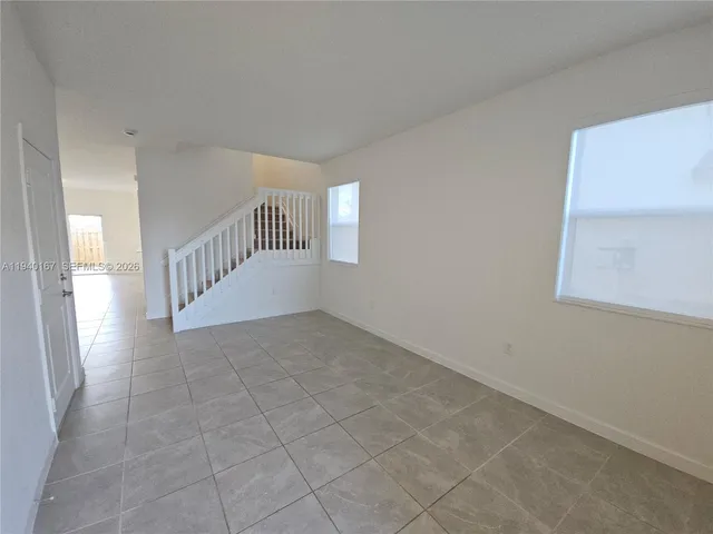 a view of an empty room with stairs
