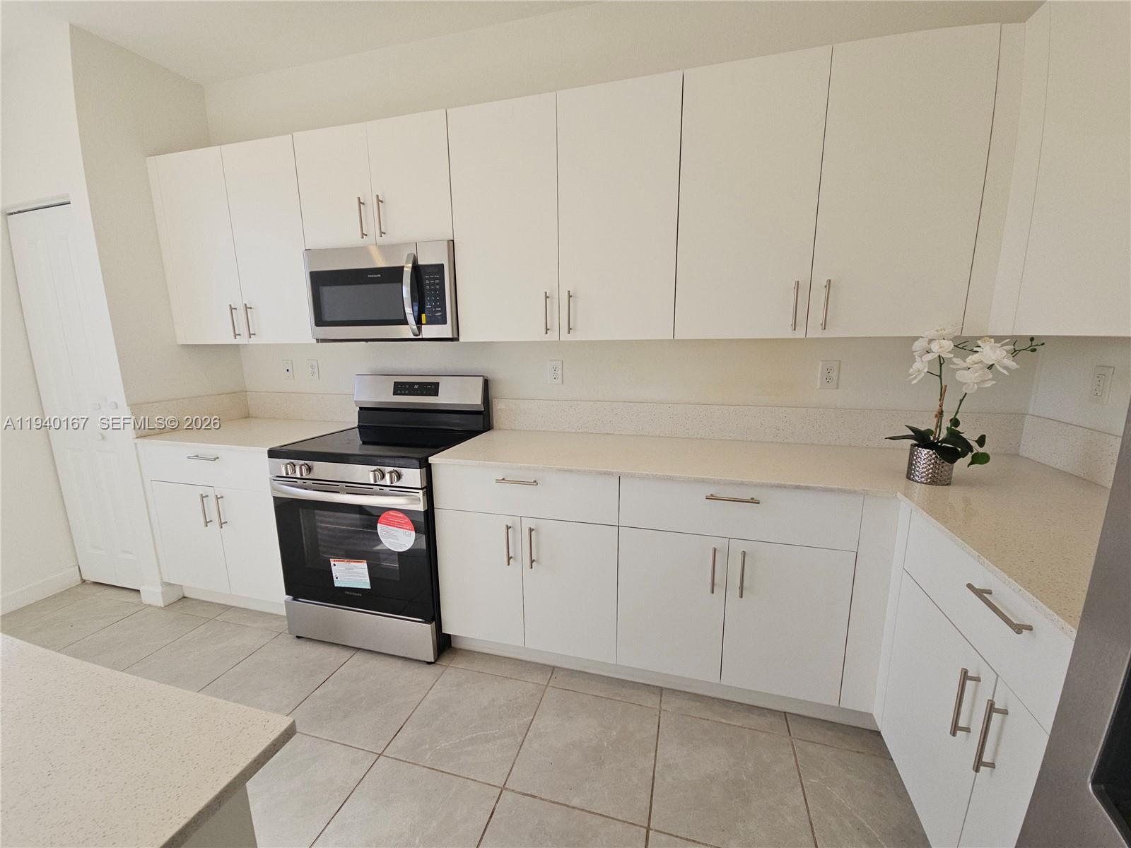 2530 Southeast 29th Street Homestead, FL 33035 - Photo 7 of 21 a kitchen with stainless steel appliances granite countertop white cabinets a sink and dishwasher
