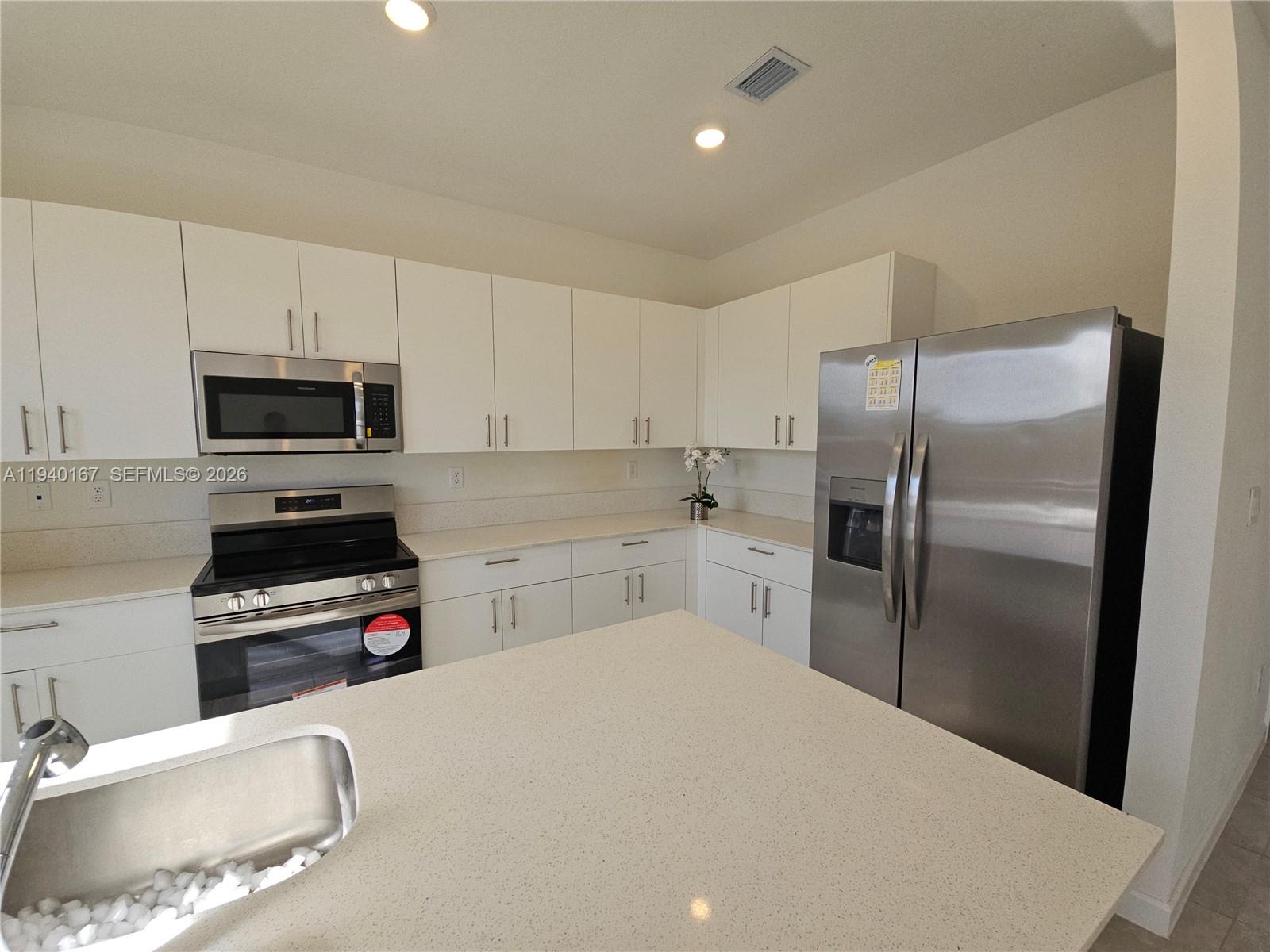 2530 Southeast 29th Street Homestead, FL 33035 - Photo 8 of 21 a kitchen with a refrigerator sink and microwave