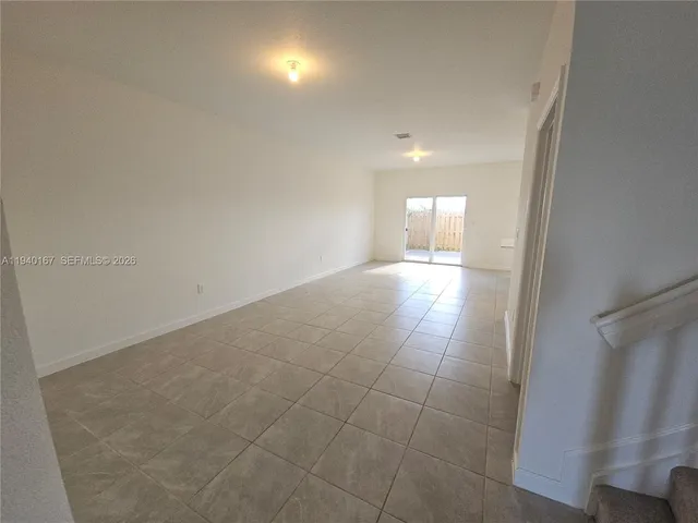 a view of an empty room and a window