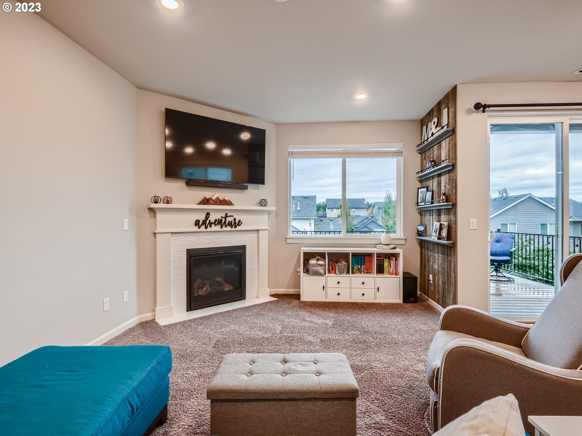 38439 Maple Street Sandy, OR 97055 - Photo 12 of 34 a living room with furniture a flat screen tv and a fireplace