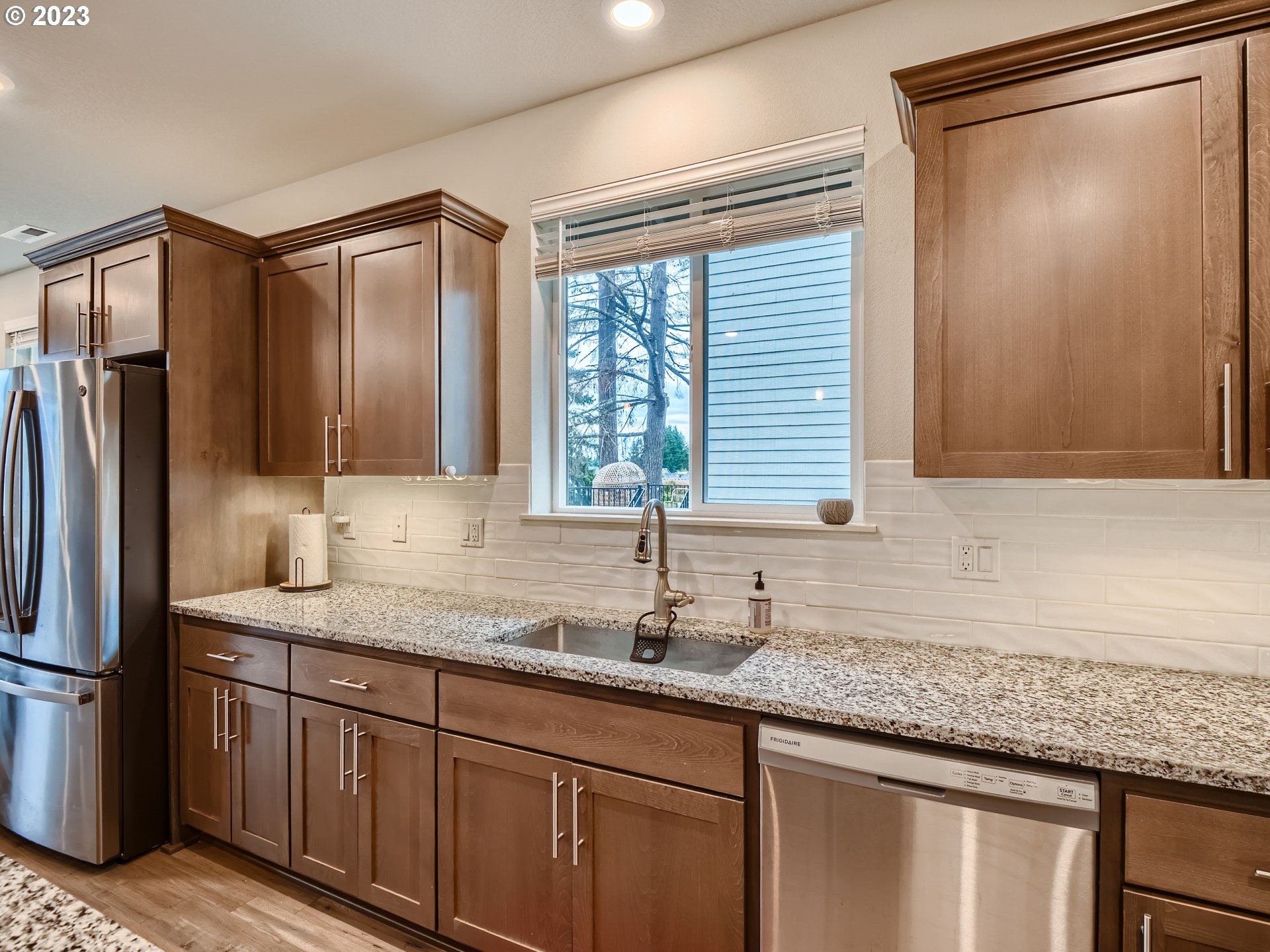 38439 Maple Street Sandy, OR 97055 - Photo 5 of 34 a kitchen with stainless steel appliances granite countertop a sink and a refrigerator