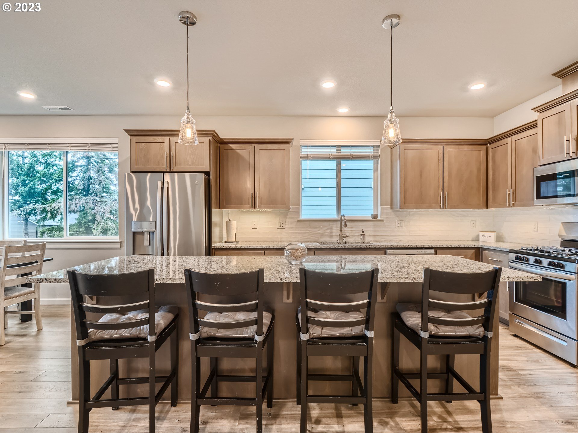 38439 Maple Street Sandy, OR 97055 - Photo 6 of 34 a kitchen with a table chairs stove and microwave