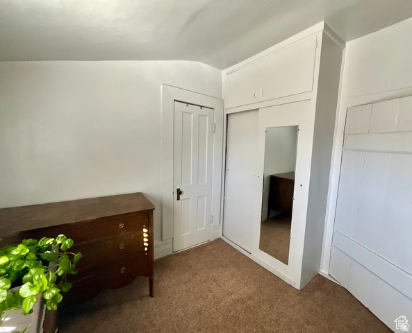 495 North Main Street Beaver, UT 84713 - Photo 16 of 18 Unfurnished bedroom featuring a closet, carpet flooring, and vaulted ceiling
