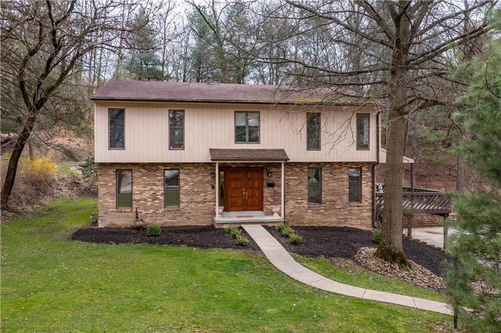970 Braddock Road Pittsburgh, PA 15221 - Photo 1 of 25 a front view of a house with a garden