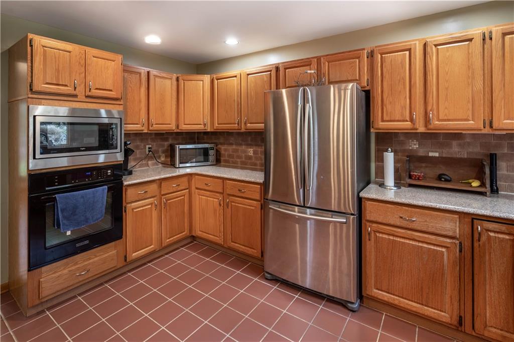 970 Braddock Road Pittsburgh, PA 15221 - Photo 11 of 25 a kitchen with a refrigerator sink and microwave