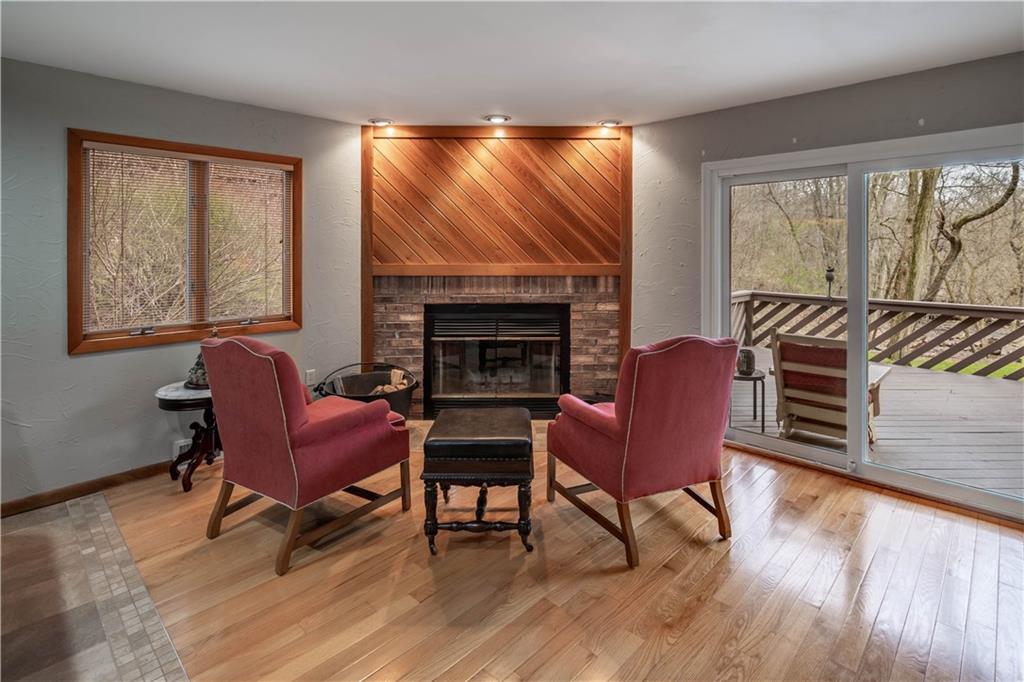 970 Braddock Road Pittsburgh, PA 15221 - Photo 5 of 25 a living room with furniture a fireplace and wooden floor