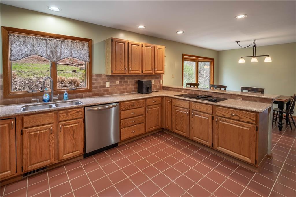 970 Braddock Road Pittsburgh, PA 15221 - Photo 8 of 25 a kitchen with stainless steel appliances granite countertop a sink a stove a counter top space and cabinets