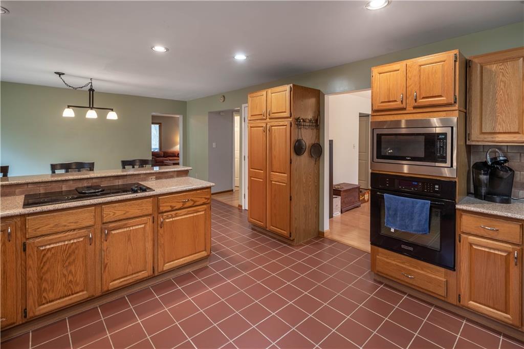970 Braddock Road Pittsburgh, PA 15221 - Photo 10 of 25 a kitchen with stainless steel appliances granite countertop a refrigerator a stove top oven and sink