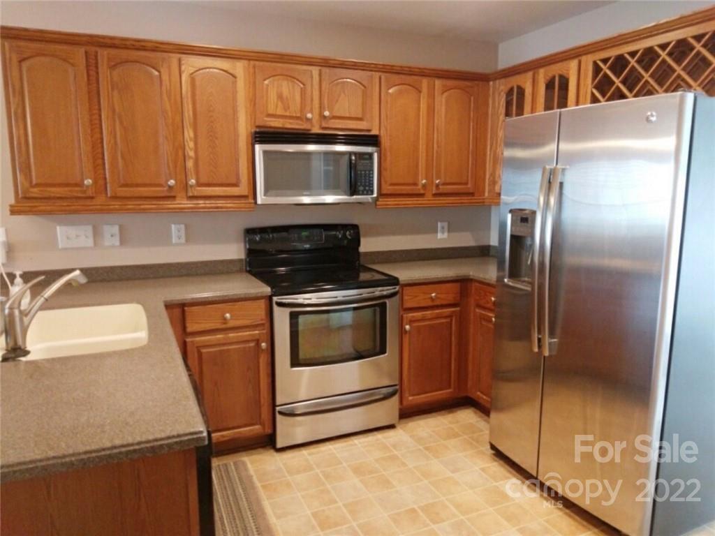 1921 Sandal Brook Road Indian Land, SC 29707 - Photo 5 of 7 a kitchen with granite countertop a refrigerator stove and microwave