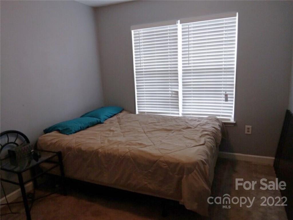 1921 Sandal Brook Road Indian Land, SC 29707 - Photo 6 of 7 a bed sitting in a bedroom next to a window