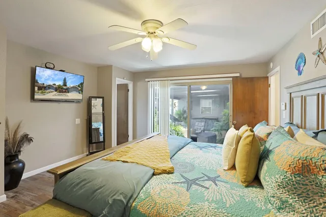 a bed sitting in a bedroom next to a window