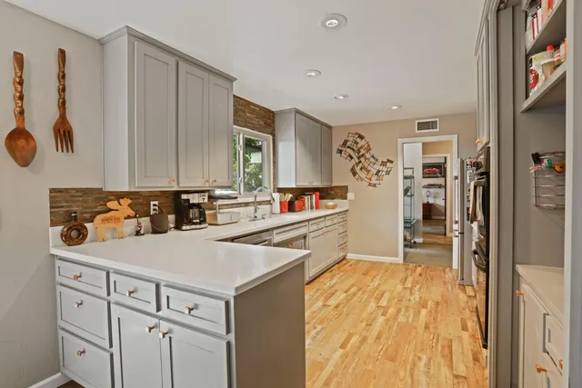 a kitchen with a refrigerator and a sink
