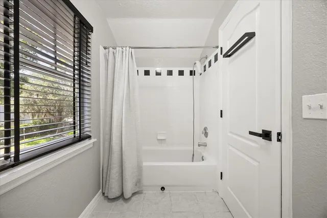 a bathroom with a bathtub and a shower