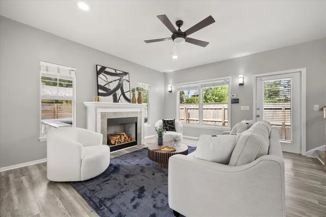 a living room with furniture a window and a fireplace