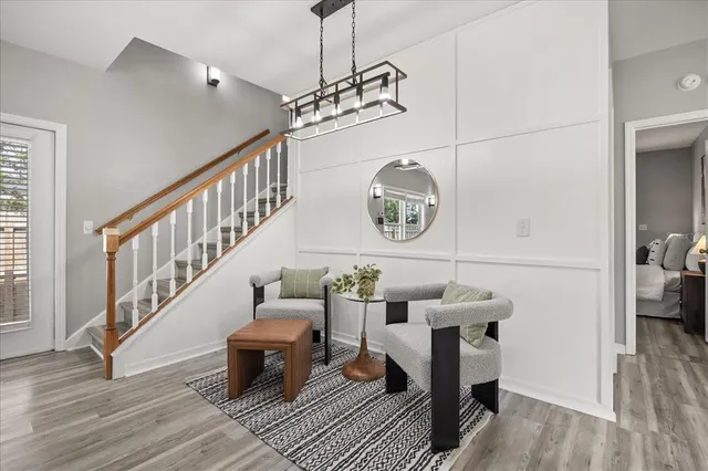 a living room with furniture and a chandelier