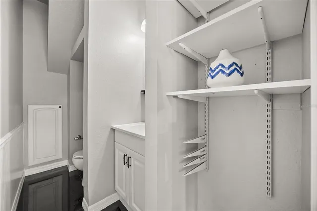 a white toilet sitting next to a bathroom sink
