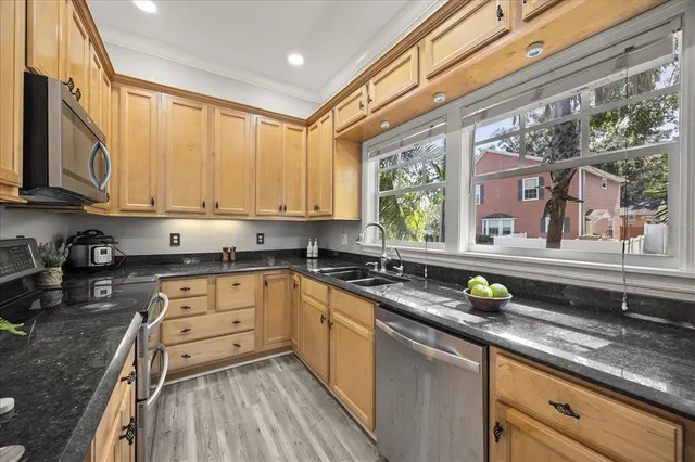 a kitchen with a sink stove and refrigerator
