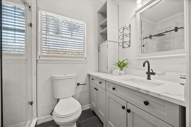 a bathroom with a toilet and shower