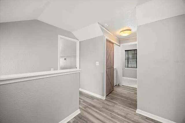 a view of a hallway with wooden floor