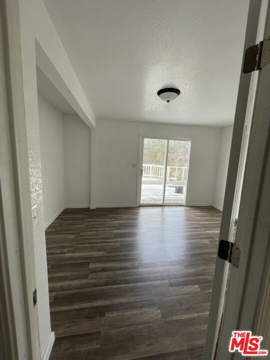 4132 Usona Road Mariposa, CA 95338 - Photo 8 of 26 a view of an empty room with wooden floor and a window