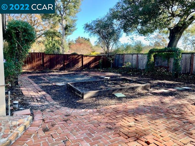 3263 Hillview Lane Lafayette, CA 94549 - Photo 4 of 24 a view of a backyard with large trees and wooden fence