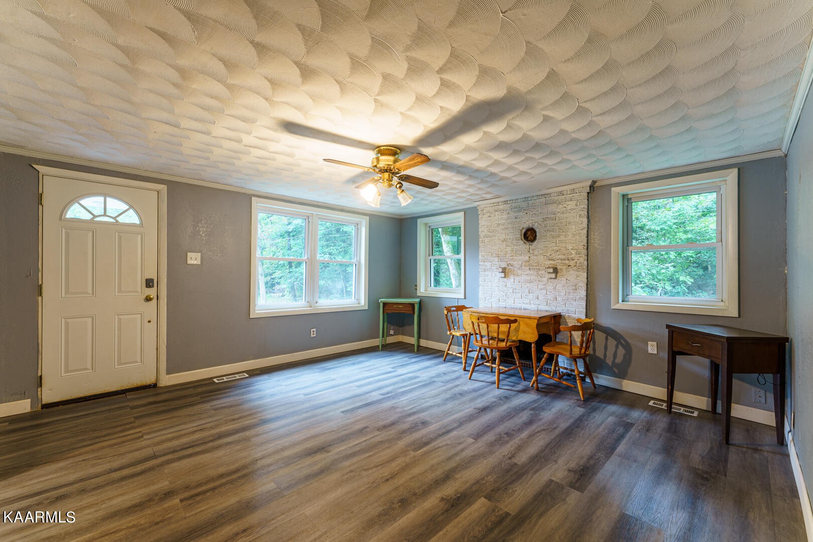 203 Duggan Road Lenoir City, TN 37771 - Photo 2 of 16 an empty room with wooden floor and windows