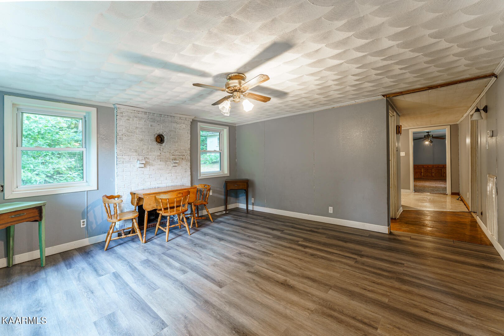 203 Duggan Road Lenoir City, TN 37771 - Photo 3 of 16 an empty room with wooden floor and windows
