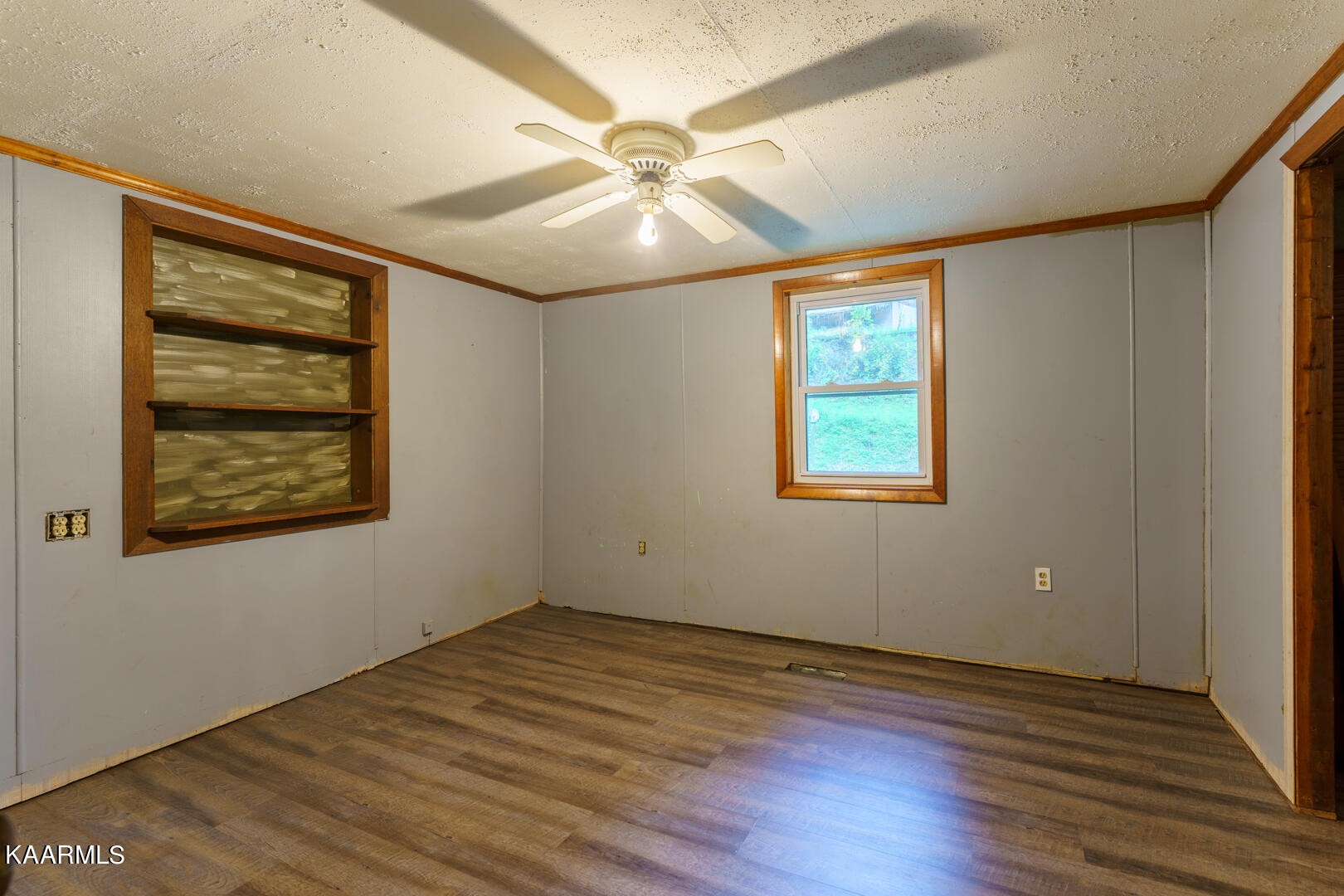 203 Duggan Road Lenoir City, TN 37771 - Photo 5 of 16 a view of an empty room with wooden floor and a window