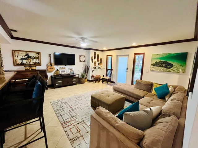 a living room with furniture and large window