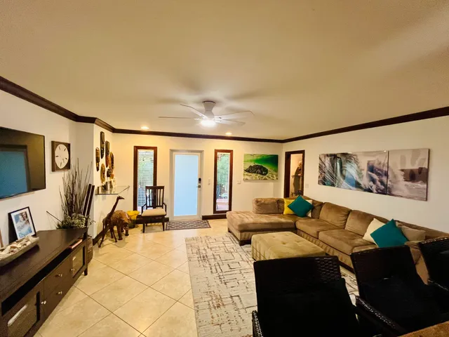 a living room with furniture and painting on the wall