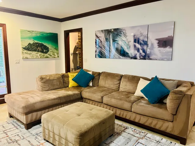 a living room with couches and painting on the wall